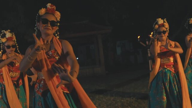 Lead Javanese Dancer with Sunglasses Smiling and Dancing at Night