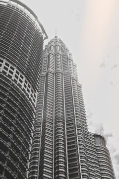 KUALA LUMPUR, MALAYSIA - SEPTEMBERER 14, 2025: Petronas Towers. Petronas Towers, also known as Menara Petronas is the tallest buildings in the world from 1998 to 2004. On a hot day during wet season.
