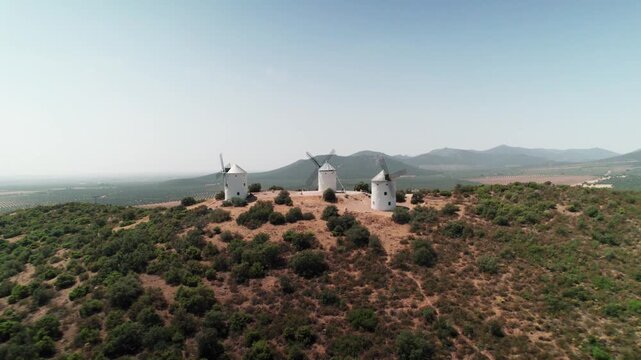 White windmills standing on hill in la mancha spain