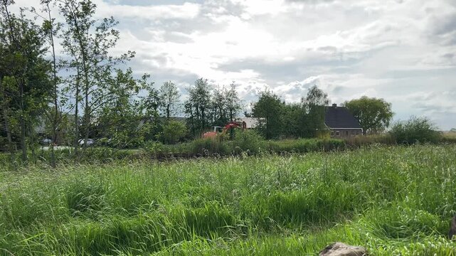 Rural Amsterdam, Rural Amsterdam meadow beside farmhouse, excavator, trees