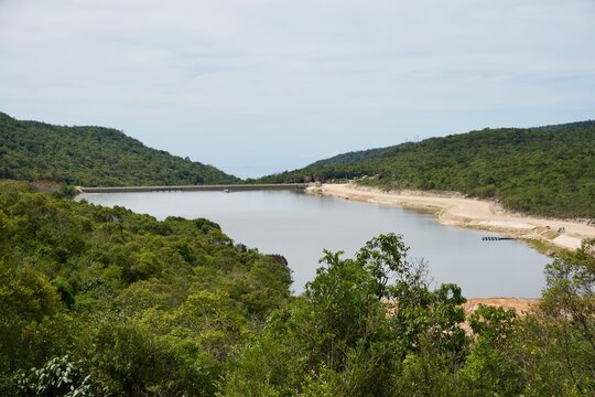 Peaceful Reservoir Surrounded by Lush Green Hills and Forest