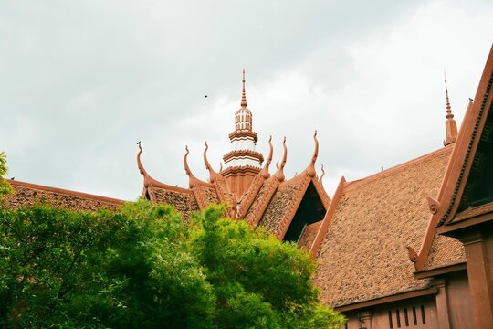 Traditional Buddhist Temple Roofs and Ornate Architecture Under Cloudy Sky