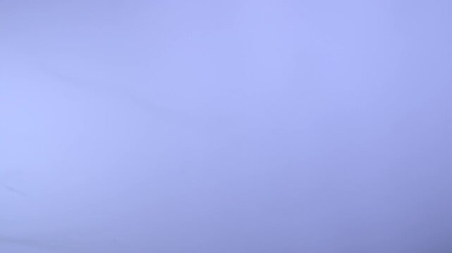 Blue translucent plastic film forms soft flowing folds with luminous highlights. Concept abstract background for packaging, banners, websites, advertising and digital design.