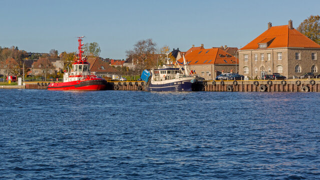 Red Tugboat and Fishing Trawler Vessels at Dock in Fredrikstad Norway