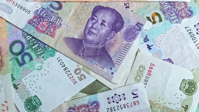 Chinese yuan (CNY) or renminbi (RMB) bills of diffrent value, close-up. Top view footage. Saving money, financial income and growth, business concept