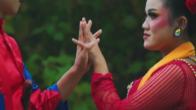 Detailed Close-Up of Indonesian Dancers' Intertwining Hands