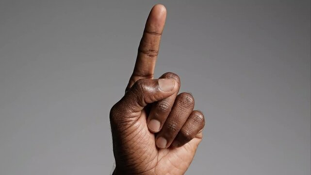 Dark Skin Hand Showing One Finger Upward Number One Gesture