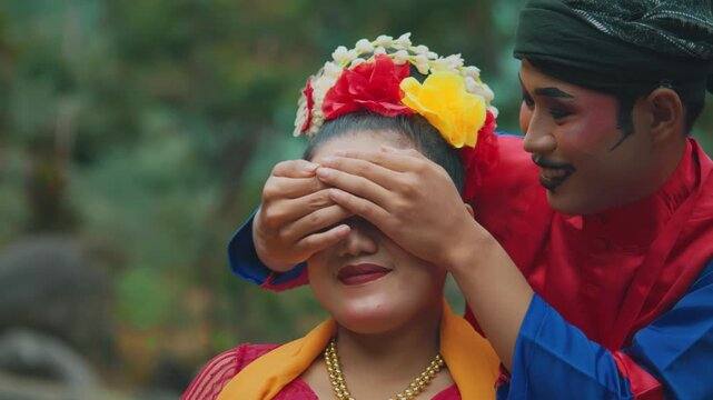 Javanese Male Dancer Surprising Female Partner from Behind