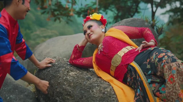 Dramatic Romantic Scene of Traditional Indonesian Dancers on Rock