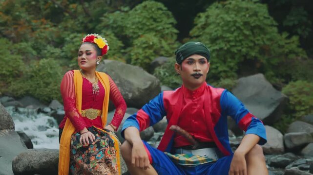 Indonesian Folk Dancers Posing in Natural River Environment