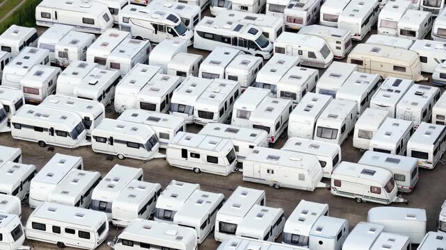 Aerial view of a caravan parking lot with many white campers