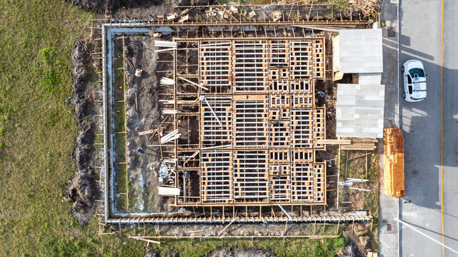 Aerial view of a residential construction site featuring pre-cast concrete structures and workers on the ground in Florianopolis, Santa Catarina, Brazil.
