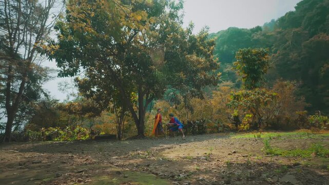 Traditional Indonesian Couple Standing by Forest Tree