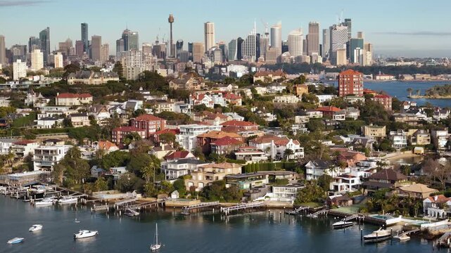 Aerial drone view of the harbour side suburb of Point Piper in East Sydney, NSW, Australia with Sydney City and Harbour Bridge in the background on a sunny morning in August 2026 