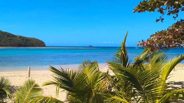Scenic view of idyllic tropical island with white sandy beach and turquoise ocean water in Yasawa Islands, Fiji