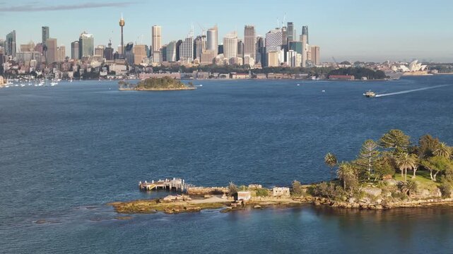 Aerial drone view of Shark Island on Sydney Harbour in East Sydney, NSW, Australia with Sydney City and Point Piper in the background on a sunny morning in August 2026