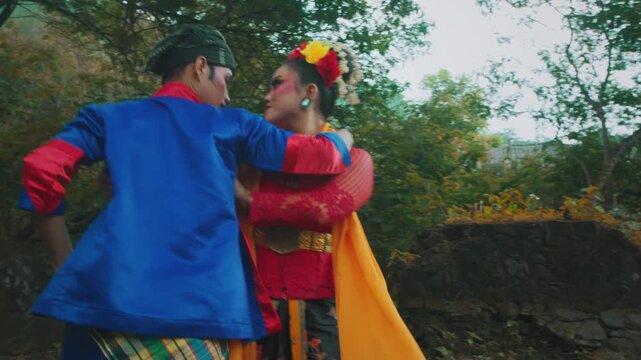 Man Performing Silat Martial Arts Move with Female Dancer