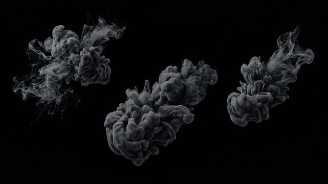 Abstract black and white smoke plumes swirling in slow motion on dark background