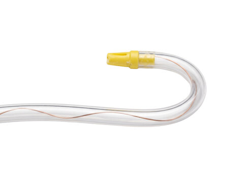 Dental saliva ejector suction tube clear plastic medical catheter with copper wire and yellow tip isolated on white background professional clinical dentistry equipment tool close up view macro