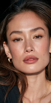 Portrait of a Beautiful Woman with Wavy Hair and Gold Earrings