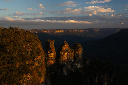 Scenic sunset view of the famous Three Sisters rock formation in Blue Mountains National Park, New South Wales, Australia

