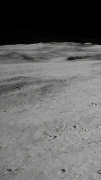 The scene shows the surface of the moon with grey soil, shallow craters, and ridges. The black sky provides a stark contrast to the landscape. Footprints are visible in the soil.
