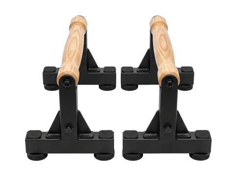 Wooden pushup bars parallettes calisthenics fitness equipment isolated on black background for home gym strength training, bodyweight exercise, gymnastics, crossfit workout, and muscle building.