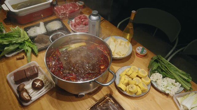 Close-up Slow Motion of Boiling Spicy Hot Pot with Assorted