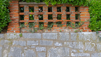 Fototapeta premium Orange Brick Fence at Top of Stone Wall at Town Park in Opatija Croatia