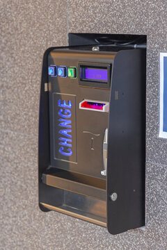 Euro Coins Change Money Changer Machine at Wall of Public Toilet WC