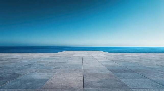 Minimal stone terrace and infinity edge overlooking calm blue sea under a clear sky, serene and peaceful horizon