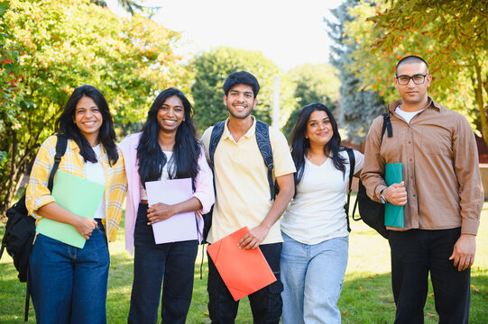 Indian university students standing together on campus backyard