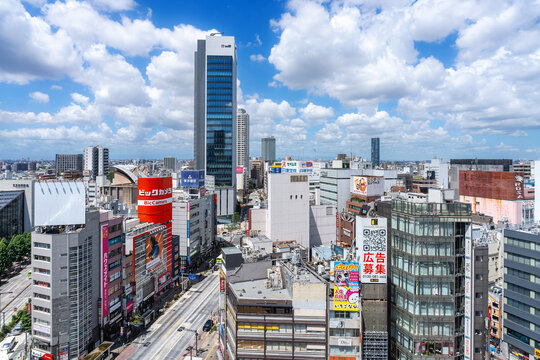 Modern city skyline and commercial street on sunny day in Toshima, Ikebukuro, Tokyo, Japan