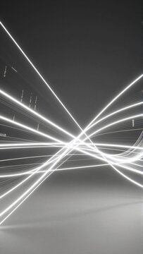 black white photograph long exposure shot light trails light trails arranged diagonal line creating sense movement depth lines white appear glowing giving futuristic abstract feel background solid