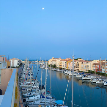 boats in the harbor. Morning on the street with a pier in Agde, France . Morning sky with an echo above the pier. Place for text.
