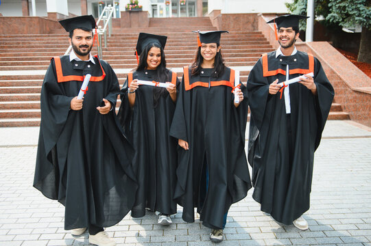 Indian graduating students celebrating academic achievement with diplomas