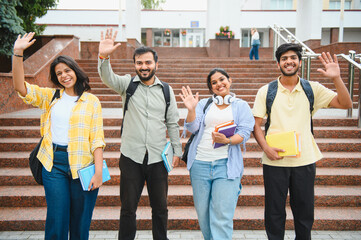 Obraz premium Group of indian students waving hands on campus