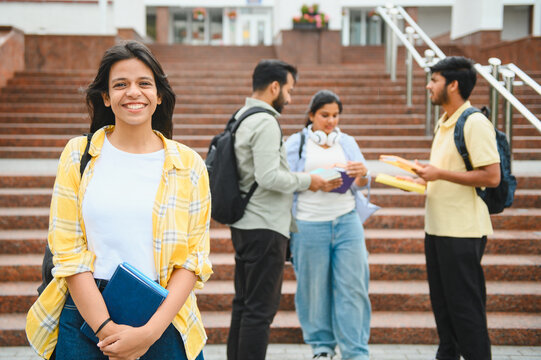 Happy indian student smiling on university campus