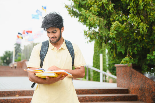 Indian student reading books on university campus
