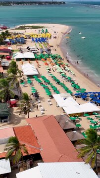 Aerial panning shoot of turquoise water beach at Maceio Alagoas Brazil. Gunga Beach tourism landmark at Maceio Alagoas Brazil. Relaxation scenery. Brazilian Northeast beach.  