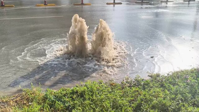 Sewage water overflowing from road drain after storm