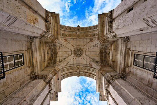 Low angle view of the ornate stone ceiling inside the historic Rua Augusta Arch in Lisbon, Portugal