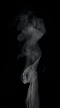 White natural rising steam from food or hot drink isolated on a black background. Сan be used in any projects with hot food.