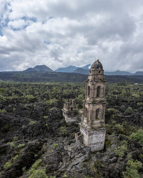 Aerial view of the historic church ruins of San Juan Parangaricutiro surrounded by solidified lava fields from the Paricutin volcano in San Juan Parangaricutiro, Michoacan, Mexico.
