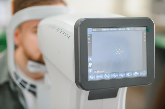 Patient undergoing vision test with modern autorefractor machine