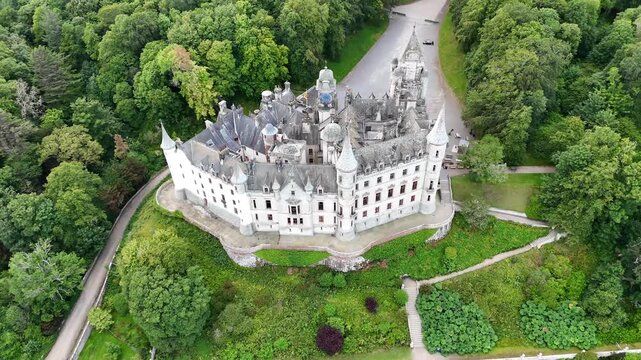 High angle aerial drone video of Dunrobin Castle, historic French chateau style stately home in Sutherland, Scottish Highlands, United Kingdom