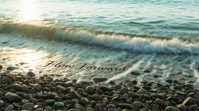 Flow Forward - Inspirational quote on beach waves and pebbles at sunset
