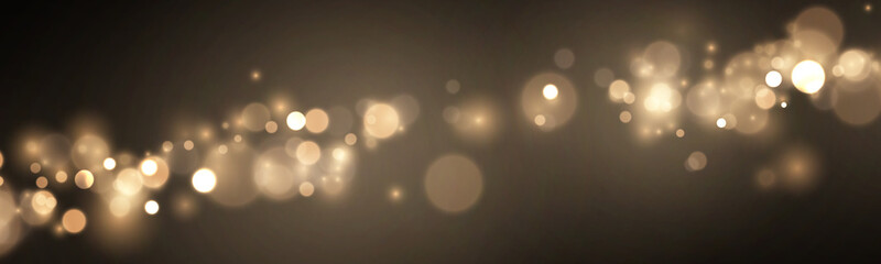 Abstract golden glitter sparkles against a dark cosmic background. Soft bokeh circles and radiant dust create an elegant luxury effect. Ideal for holiday artwork. © Freesstock
