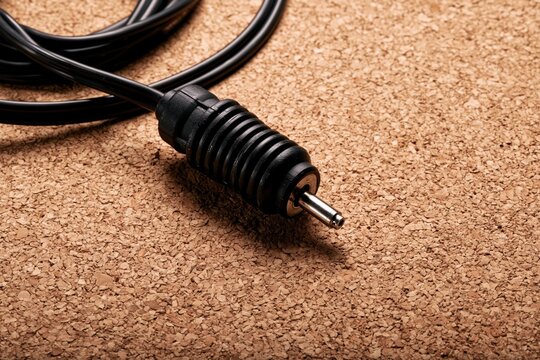 Lamp Cord Strain Relief Part with Coiled Cable on Cork Surface