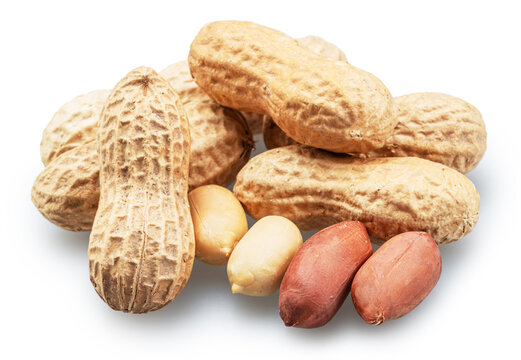 Group of whole and cracked peanuts isolated on a white background.